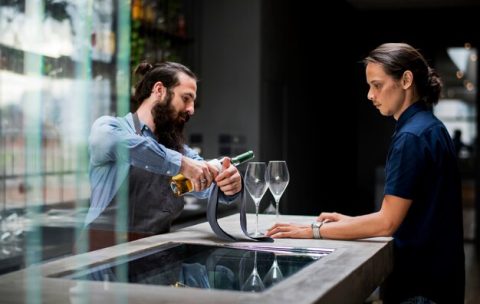 bartender-pouring-wine-glass_53876-83607